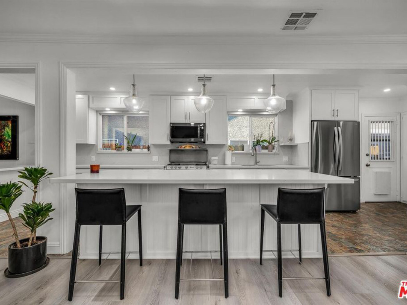 Modern white kitchen with marble counters.