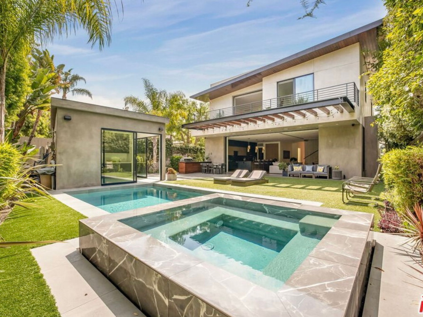 A modern Southern California residence with pool, palms, and clean architectural lines.
