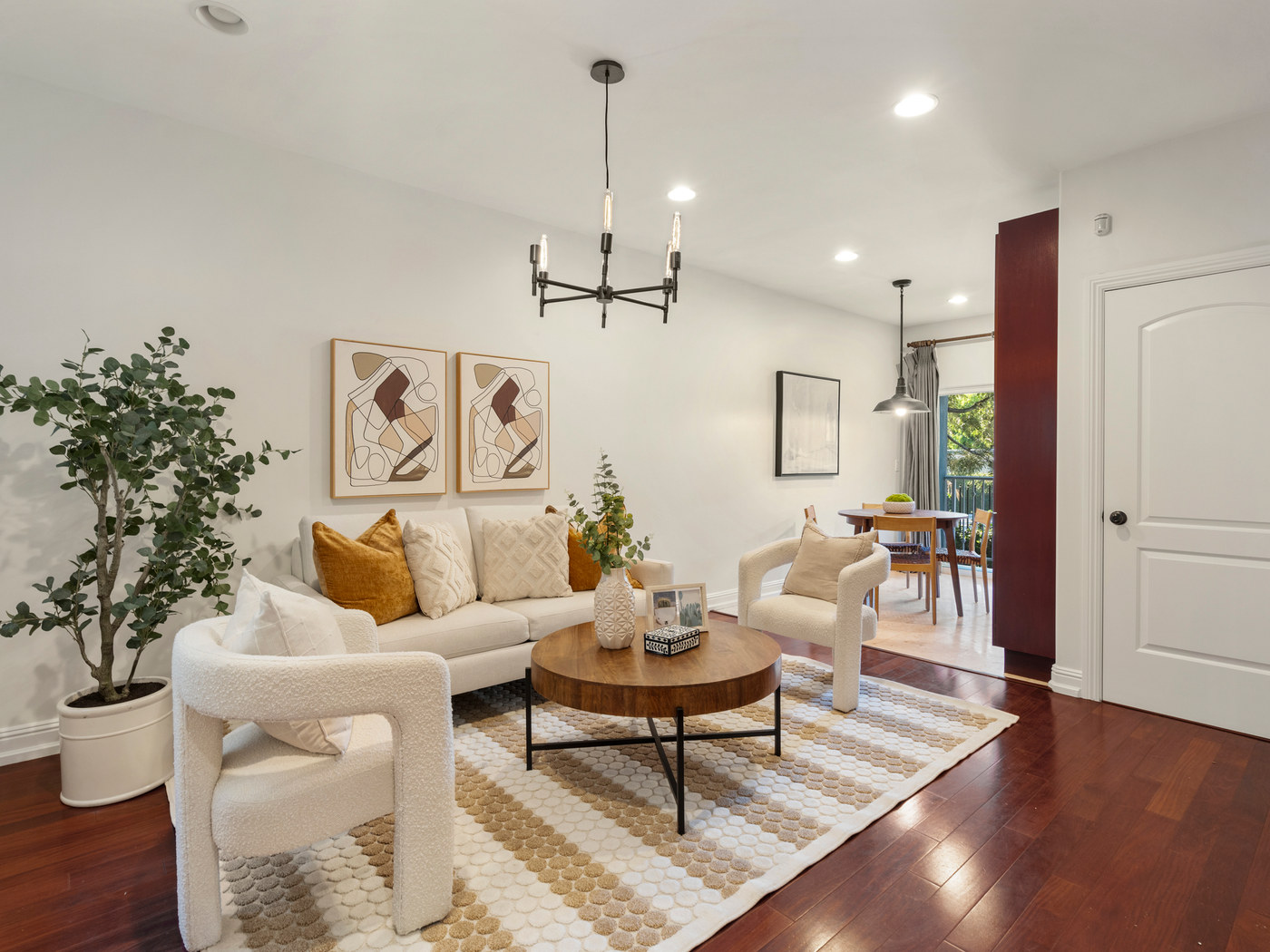 Staged living room with art and chandelier.